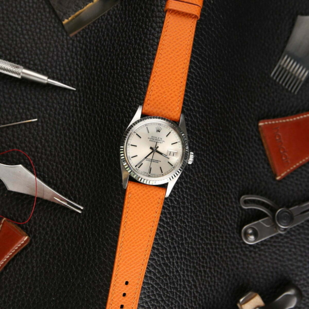 Orange Epsom with black background and tools around | Handdn